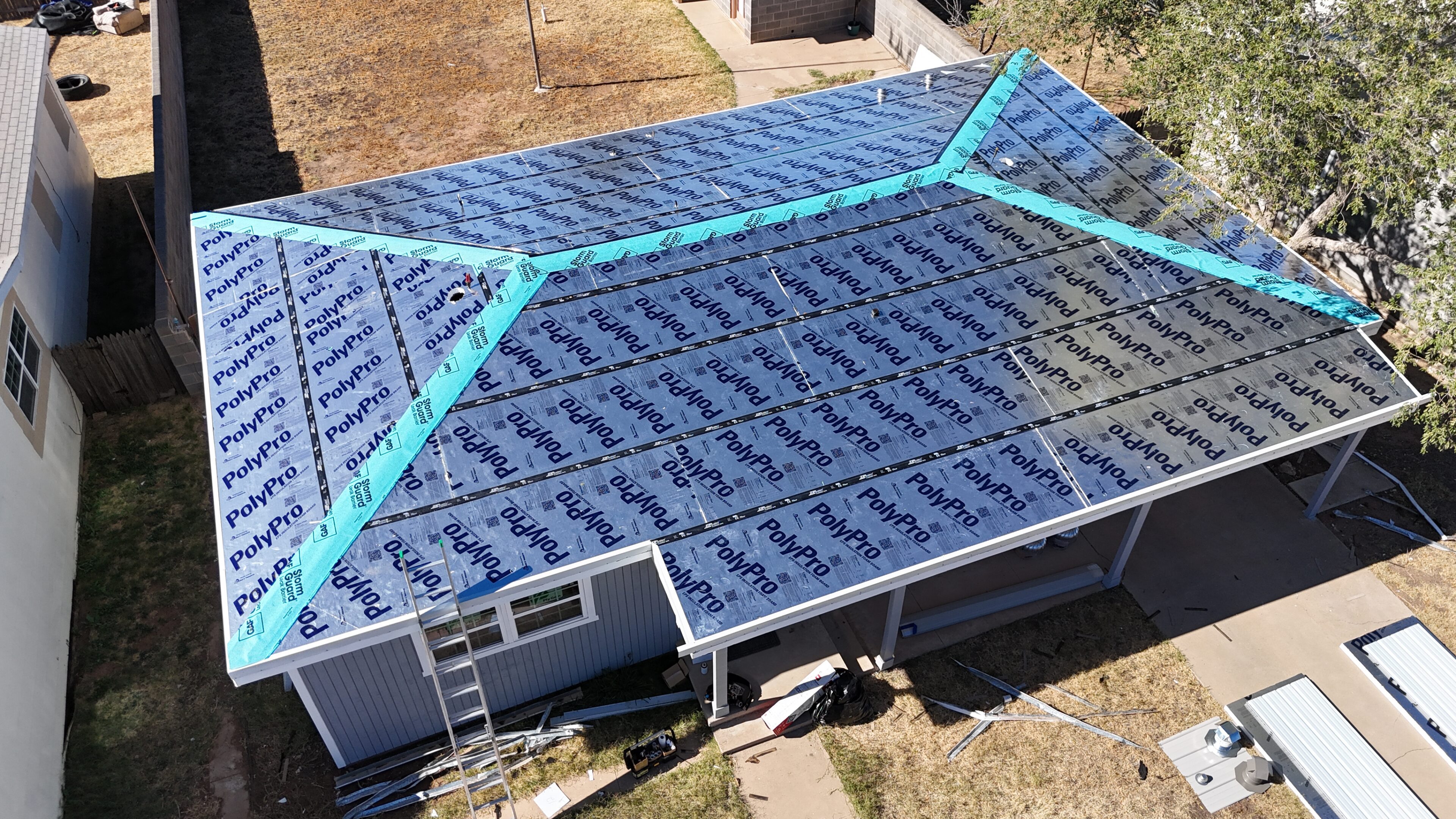 Roof installation with solar panels and blue tape markings.