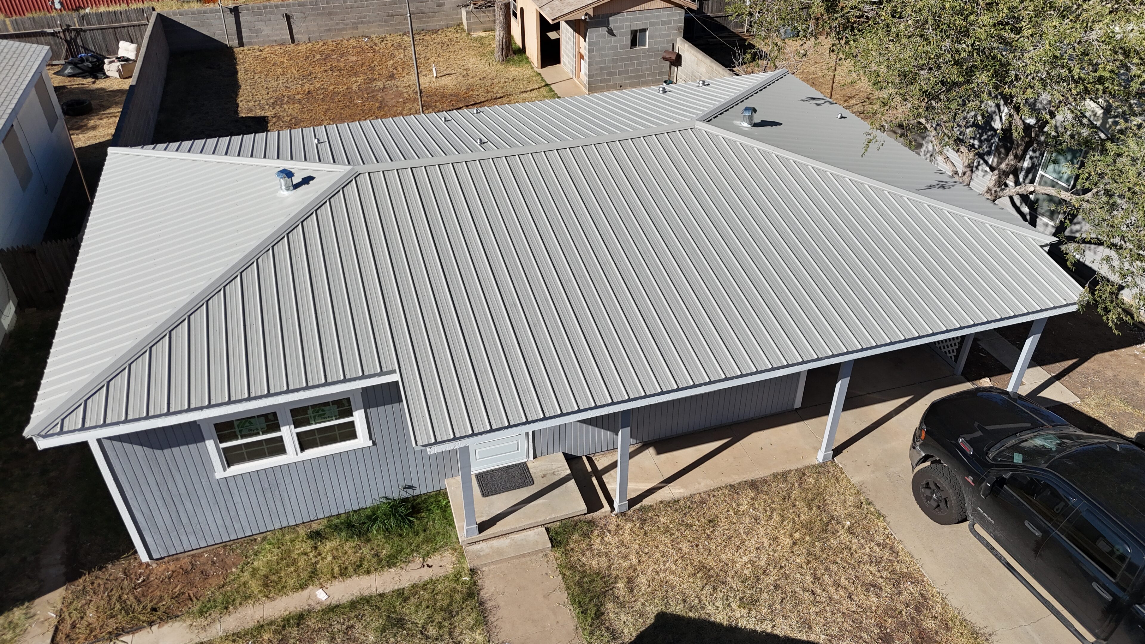 A light gray metal roof on a residential house.