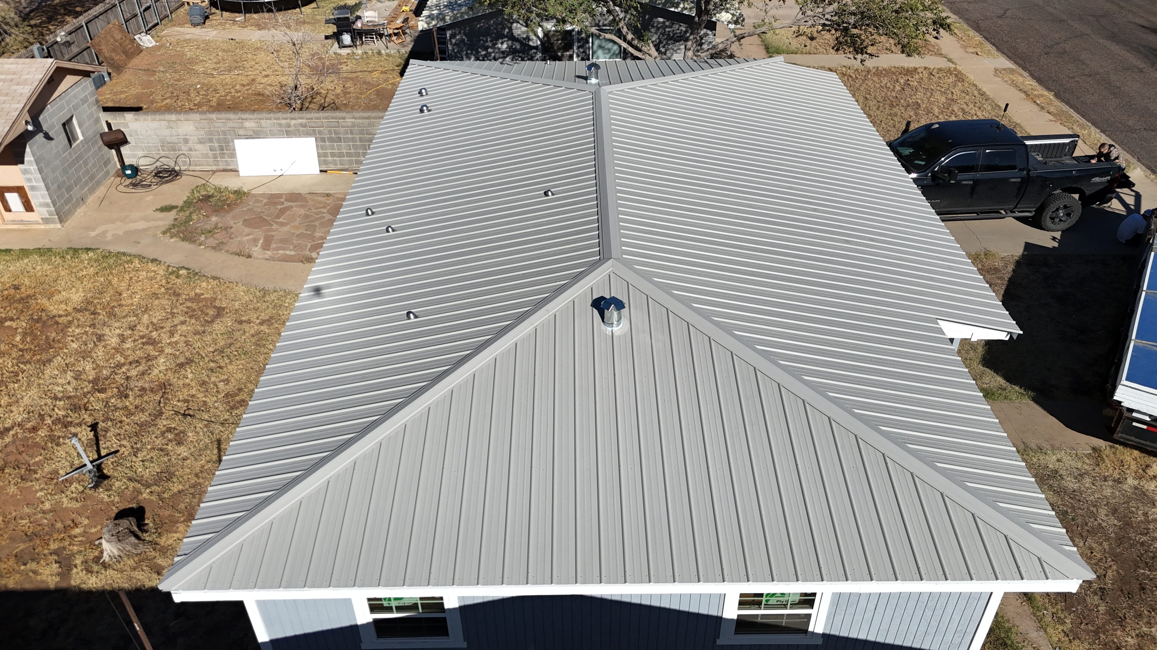A newly installed metal roof on a house with a clean, modern design.
