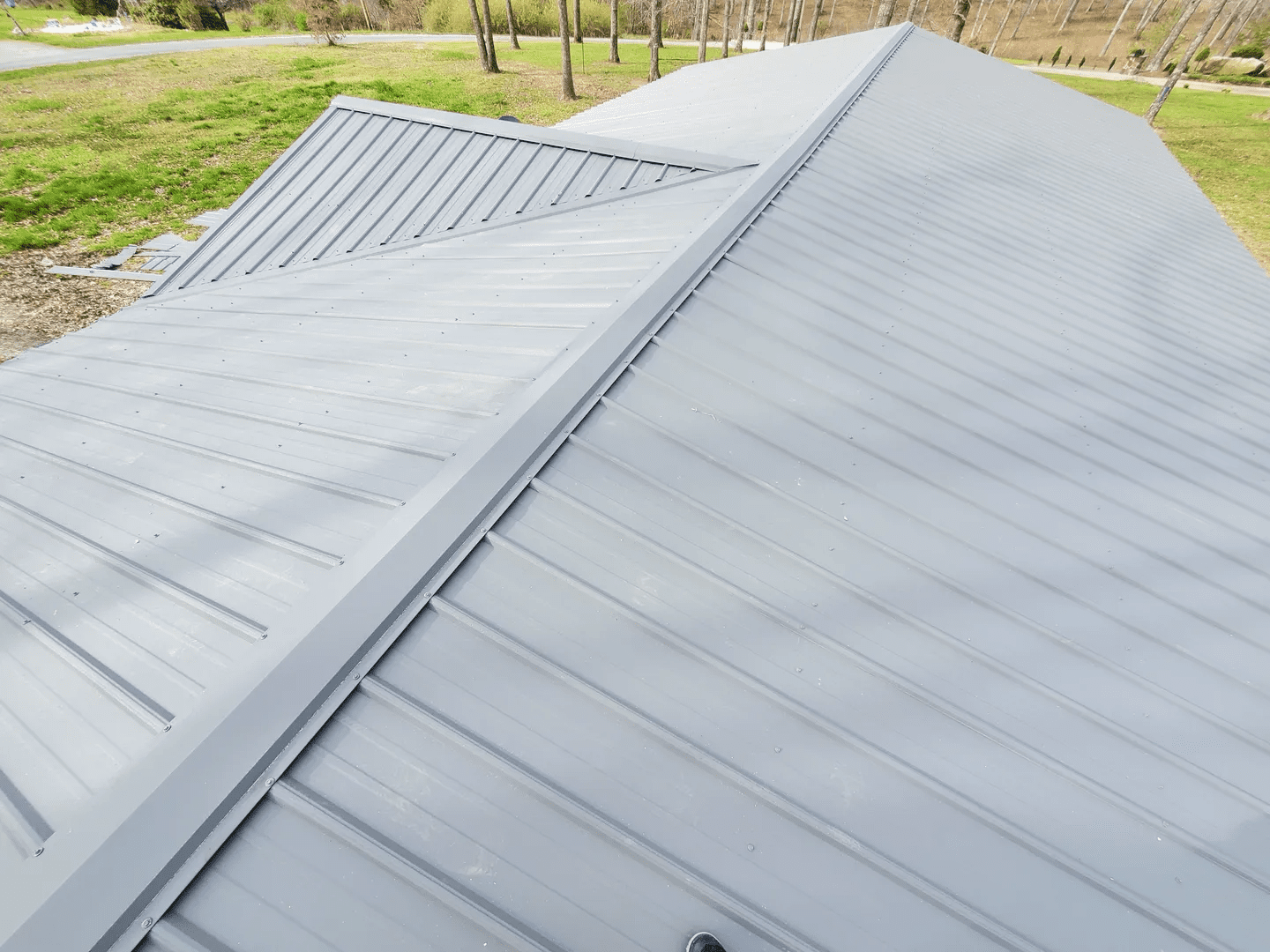 Close-up of a modern metal roof with a clean, sharp ridge line.