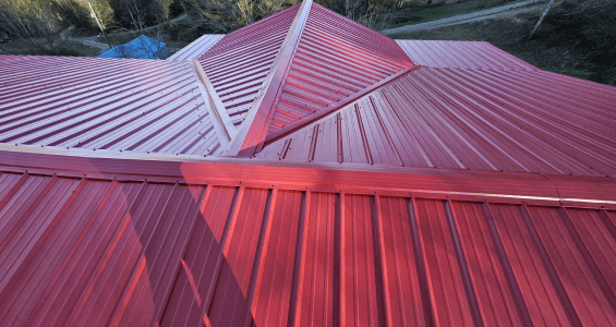 Red corrugated metal roof with multiple angled sections.